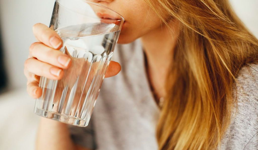 drinking a glass of water